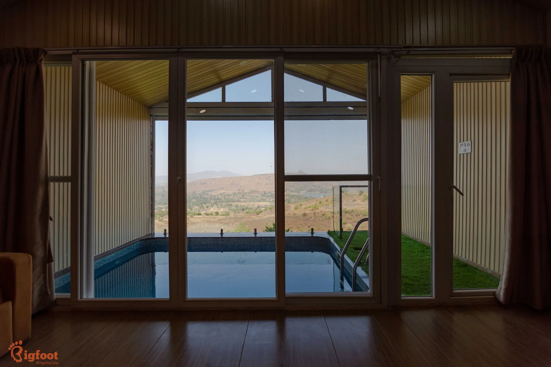 Private pool framed by glass doors with valley views at Azure Resort